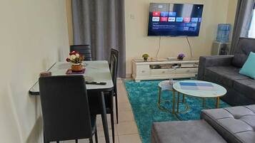 Classic Apartment, Balcony, City View | Living area | 24-inch Smart TV with digital channels