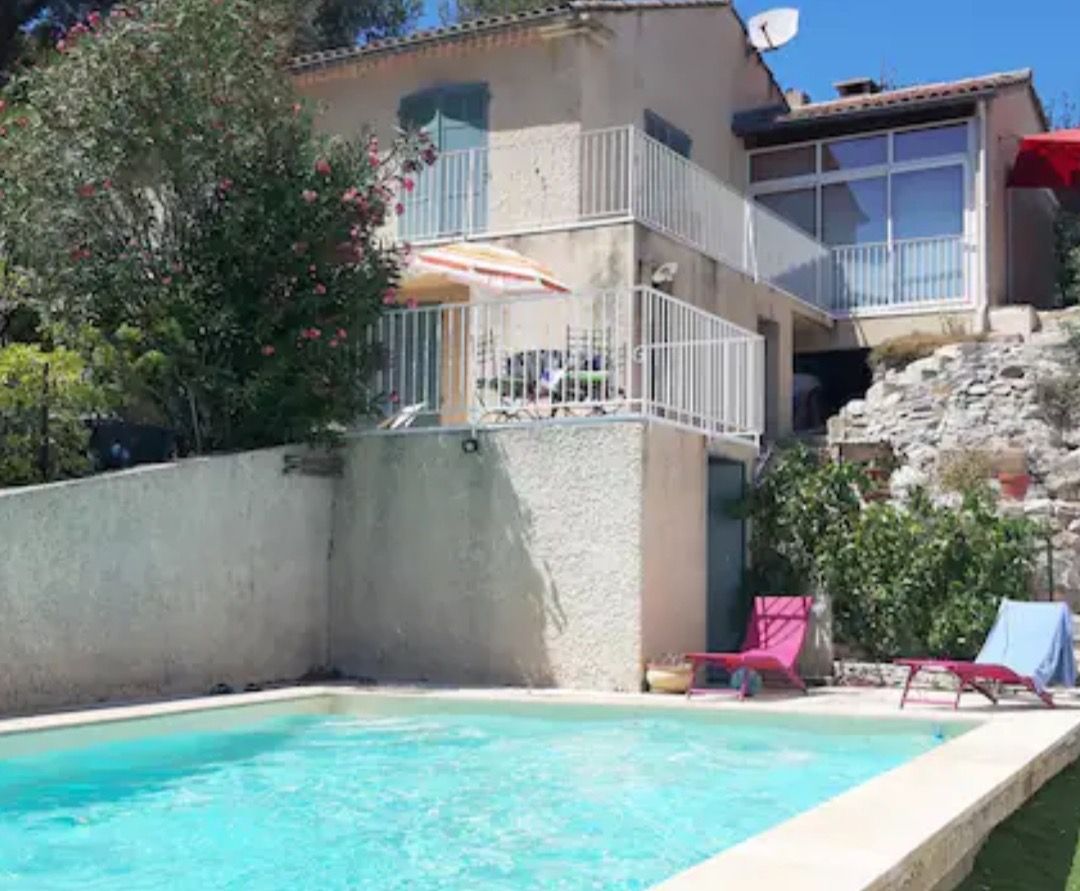 A swimming pool with a view of a building with balconies and a satellite dish.