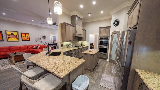 A modern kitchen with granite countertops, stainless steel appliances, and wooden cabinets. - Veteran’s Family Retreat, Spacious & Peaceful Stay Near AFB (Sherwood)