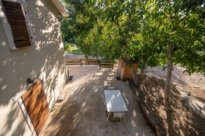 Enjoy dining or socializing in this serene outdoor space with a paved patio and comfortable seating.