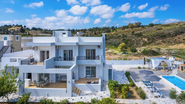 A modern two-story building with a pool, outdoor seating, and a view of the surrounding landscape. - Calm and Joy Summer House  (8527+7F4 Afantou, Greece)