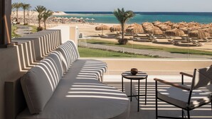 A covered outdoor seating area with a view of the beach and ocean. - JAZ Elite Riviera (Marsa Alam)