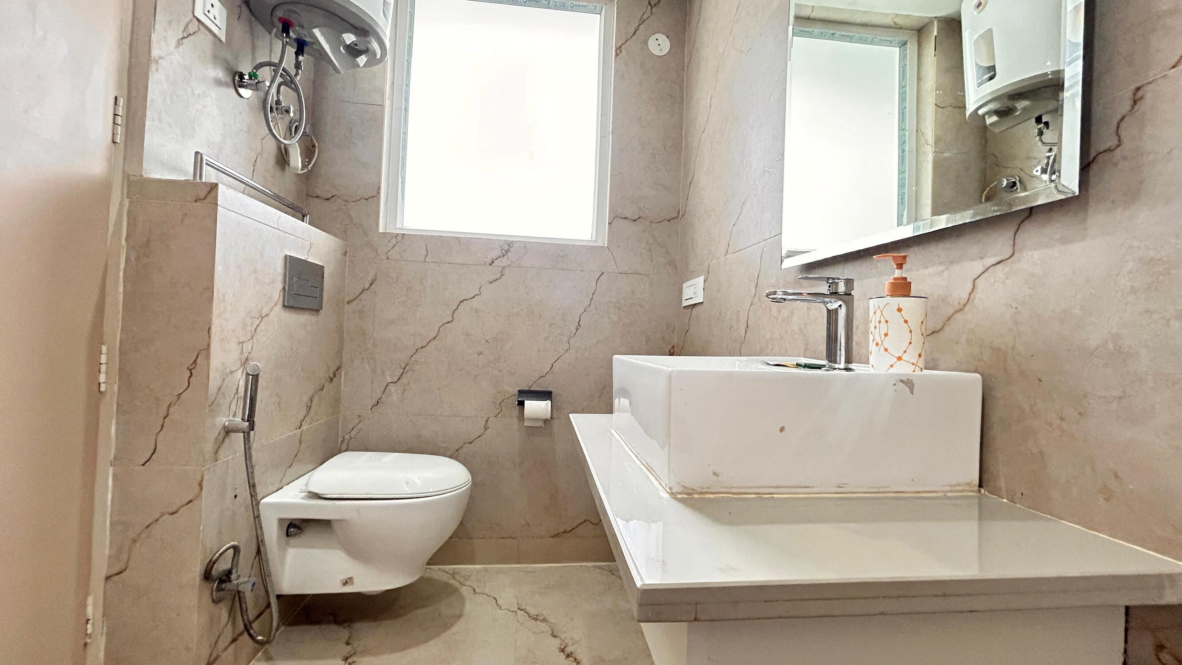A bathroom with a toilet, a sink, and a shower.
