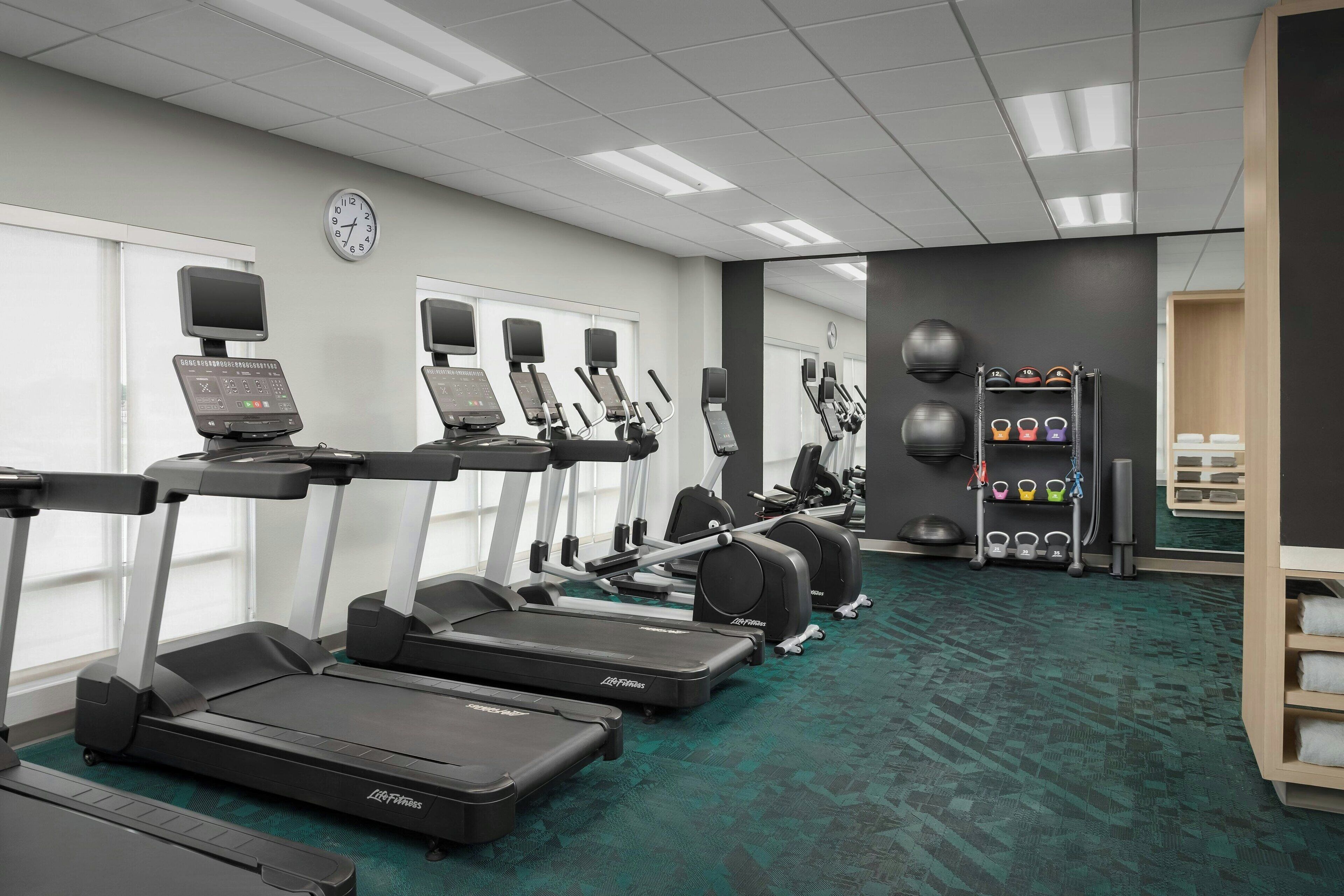 A gym with treadmills, ellipticals, and weight machines.