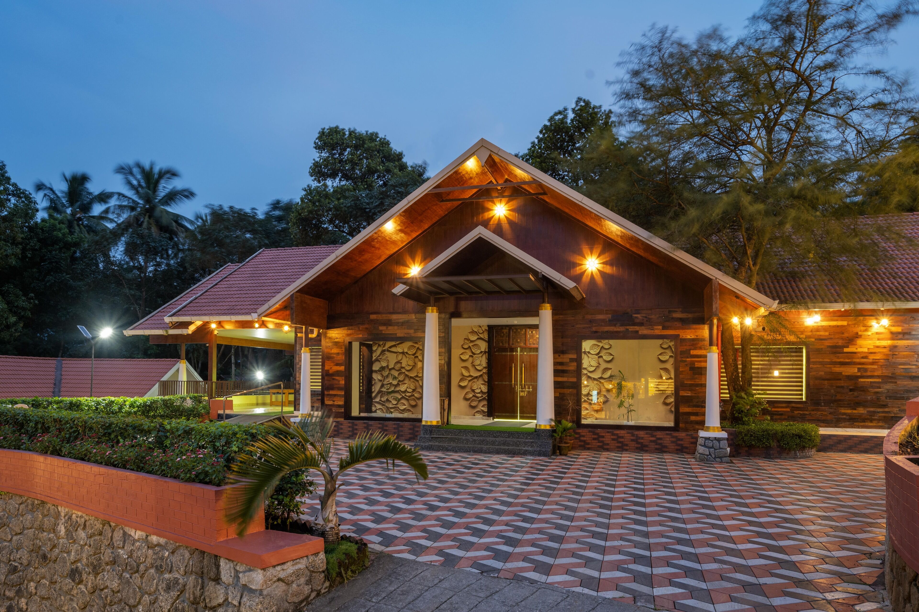 A wooden building with a tiled entrance and a landscaped garden.