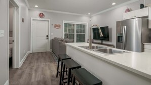 A modern kitchen with a white countertop, stainless steel appliances, and a built-in sink. - Kickoff Condo- Prime Location- Walk to UA/Strip (Tuscaloosa)