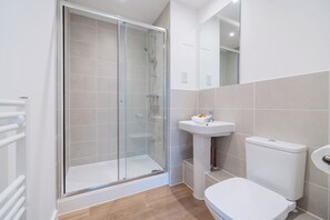 Separate bathtub and shower, hair dryer, towels