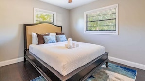 A bedroom with a bed, a ceiling fan, and two windows with blinds. - Spacious 3-BR Home with Patio, Firepit & BBQ! (Largo)