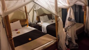 A room with two single beds, each with a canopy. - KLH RESORT (Karatu)