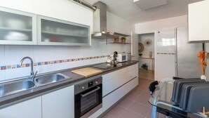 A modern kitchen with stainless steel appliances, a double sink, and a microwave. - Apartment Catania in Aguadulce - Almeria. Equipped, elegant, and with sea views (Aguadulce)