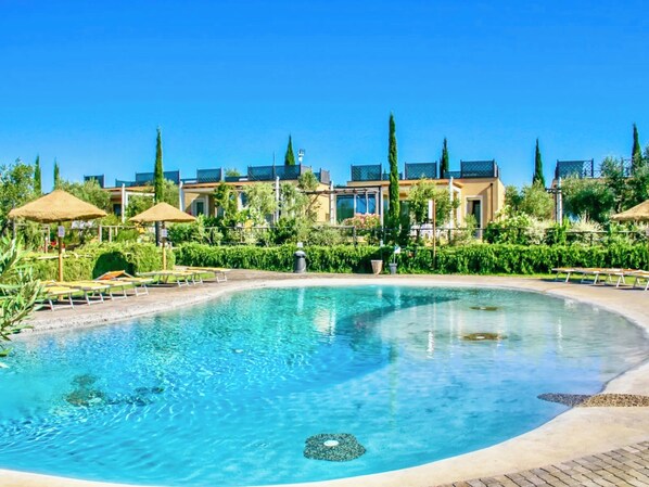 Seasonal outdoor pool, open 9:00 AM to 7:30 PM, pool umbrellas