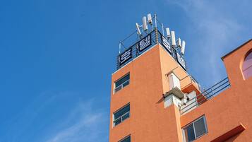 A multi-story building with a clear blue sky in the background.