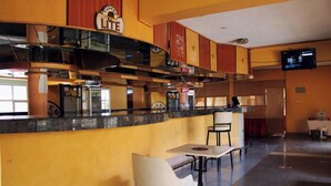 A restaurant with a counter, bar area, and seating. - Global Hotels & Suites Kitengela (Kitengela)