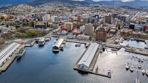 An aerial view of a city with a marina, including boats and docks.