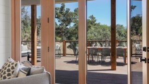 A deck with outdoor seating and a view of trees. - The Vineyard Estate at Paradise Ridge by Kohmsa (Santa Rosa)