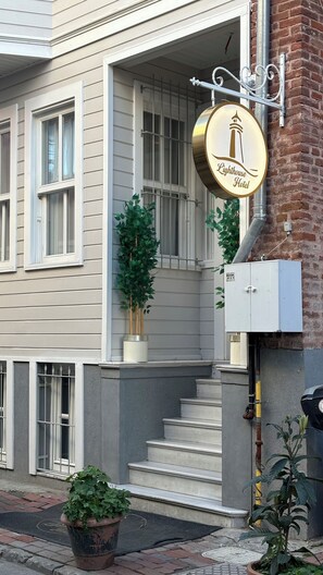 A building with a sign reading "Lighthouse Hotel" and a staircase leading to the entrance. - Lighthouse  (Istanbul)