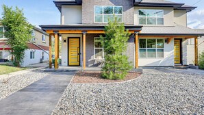 A two-story house with a front porch, a small tree, and a gravel driveway. - Hot Tub & Mtn-view Rooftop Deck: Golden Home (Golden)