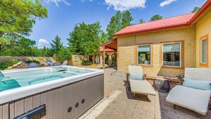 A hot tub, outdoor seating, and a house with a red roof. - Ruidoso Retreat w/ Hot Tub & Patio! (Ruidoso)