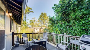 A covered patio with outdoor furniture, a grill, and a fire pit. - Rockaway Beach House - Walk to Ocean! (Rockaway Beach)