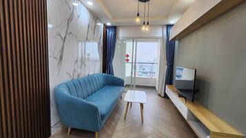 Deluxe Apartment, City View | Living area | 64-inch Smart TV with digital channels, pay films