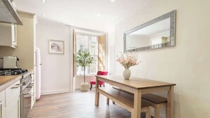 A modern kitchen with a wooden countertop, a built-in stove, and a window with a view. - Host & Stay | Yule House (Alnwick)