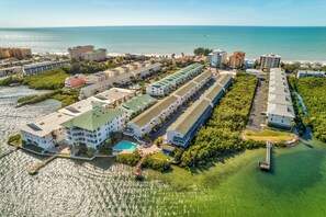An aerial view of a coastal hotel with multiple buildings, a swimming pool, and a pier. - 🐬On Waterway🌞Sea Shell 28🏖️Quick Walk to Beach🐠Fishing Dock👙Pool (Indian Shores)