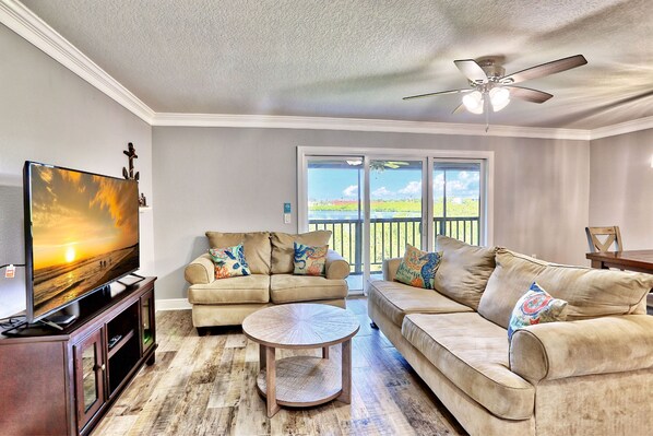 Relax in style with a large flat-screen TV, two comfortable sofas, and a cozy coffee table.