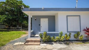 A single-story house with a front porch, a door, and a window. - Waves & Chill 1 | Jobos Guest House (Isabela)
