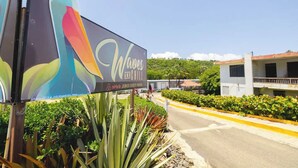 A sign for 'Waves and Chill' with an Airbnb logo, indicating a guest house.