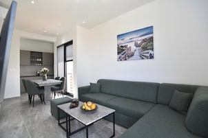 Family Apartment, Sea View | Living area | 130-cm Smart TV with cable channels