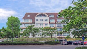 A multi-story residential building with balconies and large windows. - 1 bedroom accommodation in Oostduinkerke (Oostduinkerke)