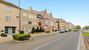 A row of residential buildings with a paved street and parked cars. - 2 bedroom accommodation in Oostduinkerke (Oostduinkerke)