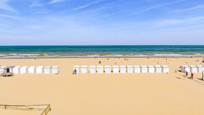 A beach with rows of white beach huts and a clear blue sky. - 2 bedroom accommodation in Sint Idesbald (Sint Idesbald)