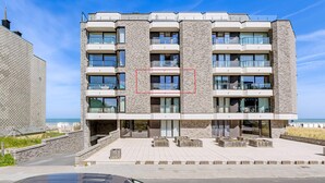A multi-story hotel with a modern design, featuring balconies and large windows. - 2 bedroom accommodation in Sint Idesbald (Sint Idesbald)