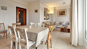 A dining area with a table and chairs, a sofa, and a coffee table. - 2 bedroom accommodation in Koksijde (Koksijde)