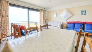 Une chambre d’hôtel avec un balcon, une table à manger, un canapé et un lit.
