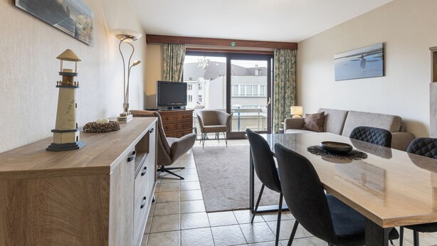 A modern hotel room with a dining area, a TV, a sofa, and a balcony with a view. - 2 bedroom accommodation in Koksijde (Koksijde)