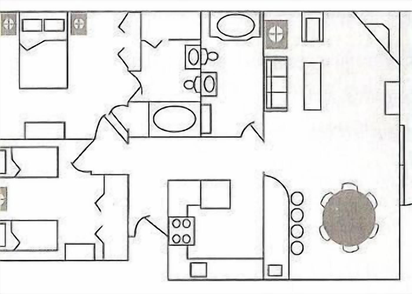 A floor plan of a hotel room with a bed, a bathroom, a kitchenette, and a dining area.
