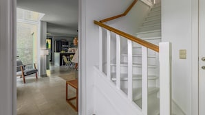 A staircase with white railings and a wooden handrail leading to a landing. - 4 bedroom accommodation in Oostduinkerke (Oostduinkerke)