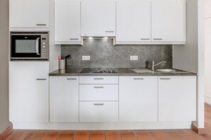 Fridge, microwave, stovetop, coffee/tea maker