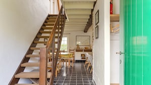 A staircase with wooden steps and a green door.