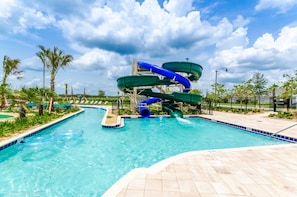 A swimming pool with a water slide, surrounded by palm trees and a clear sky. - Upstay - Modern Home w Pool Near Disney (Kissimmee)