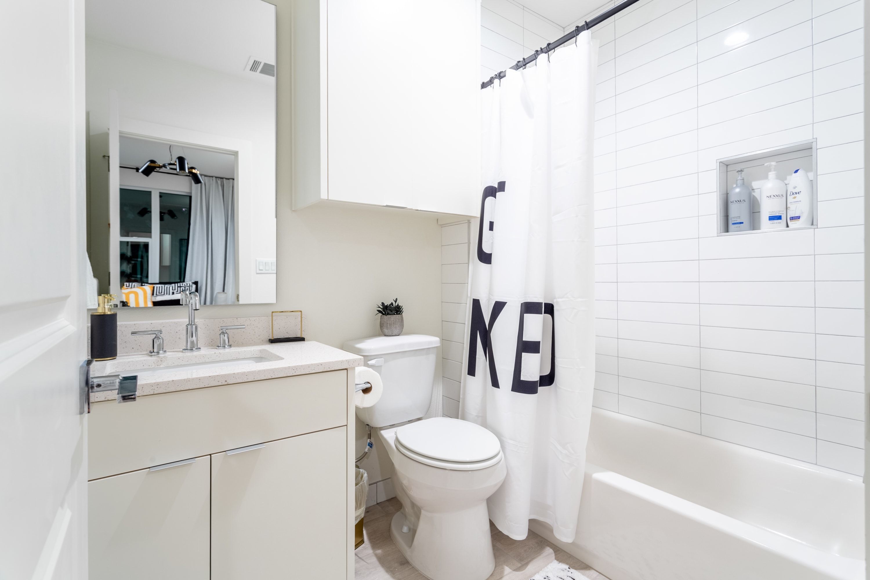A modern bathroom with a toilet, sink, and bathtub.