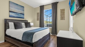 A bedroom with a large bed, a bedside table, a TV mounted on the wall, and a window with curtains. - Upstay - New Home Near Disney w Private Pool BBQ (Kissimmee)
