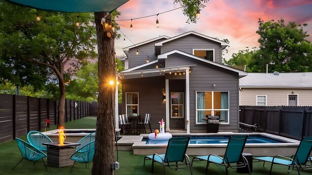A backyard with a swimming pool, outdoor furniture, and string lights. - Pool Hottub Magic School Bus 5 Mins to Downtown (Austin)
