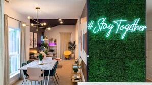 A modern dining area with a marble table, chairs, and a neon sign saying "#Stay Together". - Pool Hottub Magic School Bus 5 Mins to Downtown (Austin)