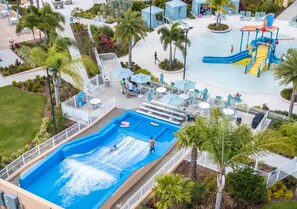 A water park with multiple pools, slides, and play structures.
