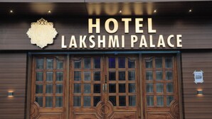 A hotel entrance with a sign reading "HOTEL LAKSHMI PALACE" and a large wooden door with multiple windows. - HOTEL LAXMI PALACE (Kekri)