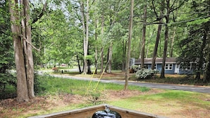 A wooden deck with a barbecue grill.