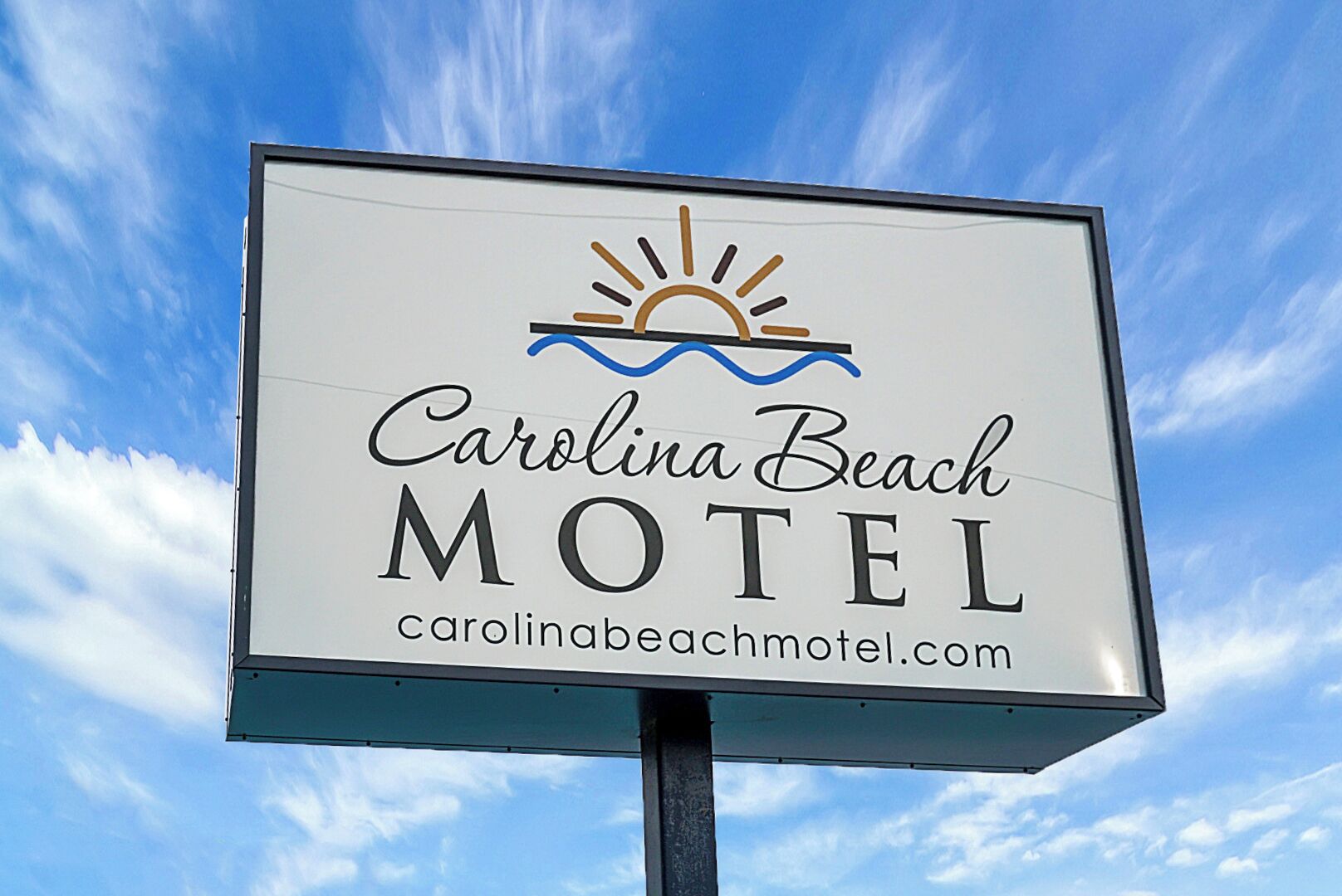 A motel sign with the name "Carolina Beach Motel" and a website address.
